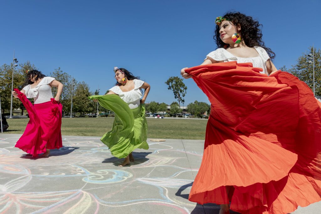 Mexican dancers performing with large skirts at an NEA Big Read event.