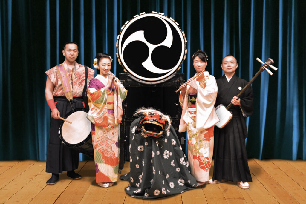 Hikaru, Japanese folk band based in Japan, pose with various instruments.