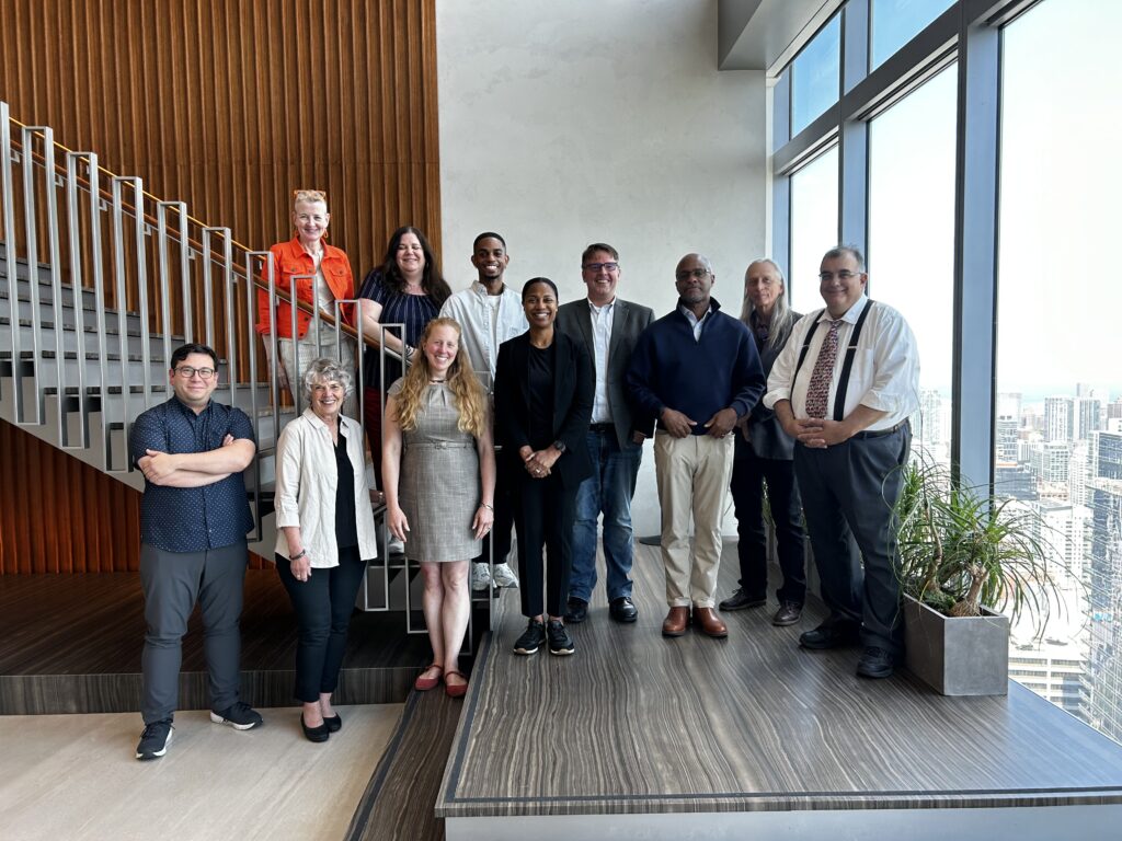 Ten members of the Arts Midwest Board, plus President & CEO Torrie Allen, posing for a photo.
